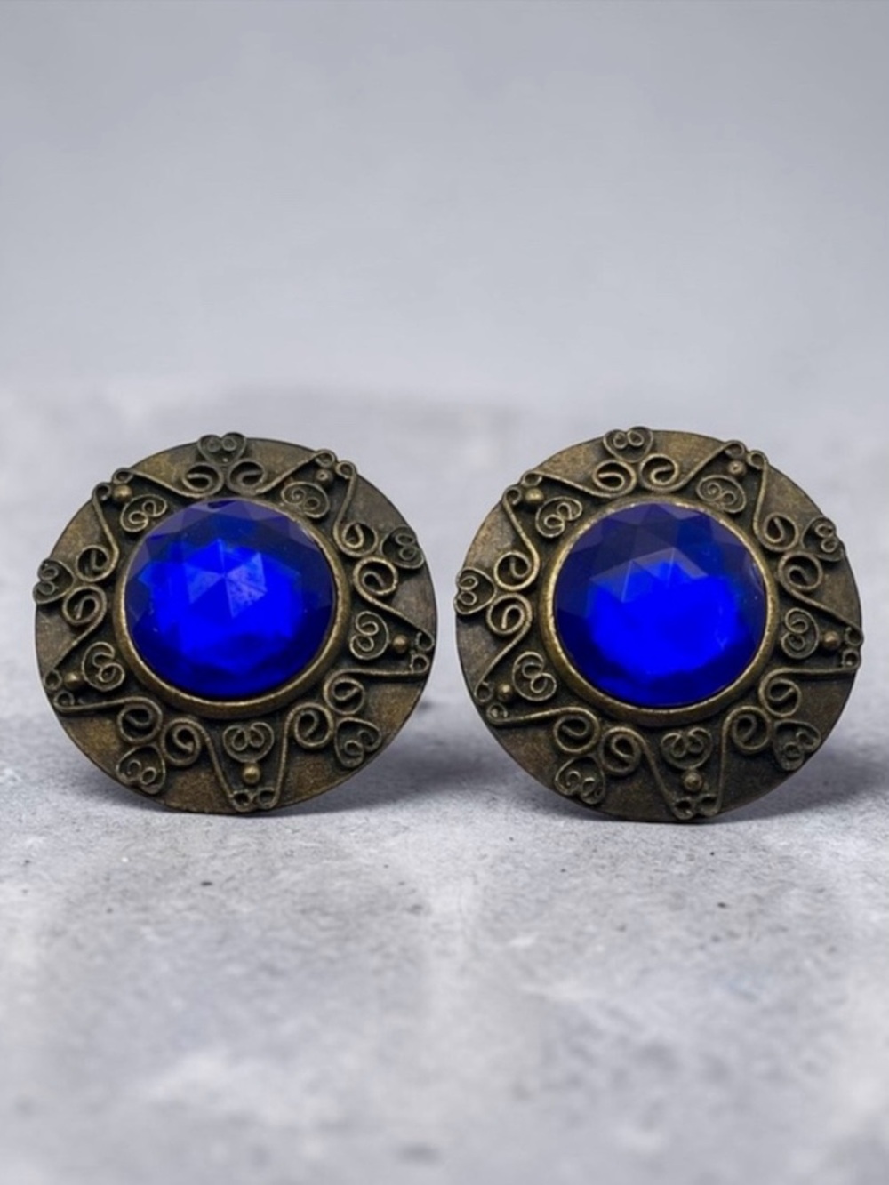 Vintage Don Lin Round Ornate Aged Gold Tone With Faux Blue Stone Clip Earrings